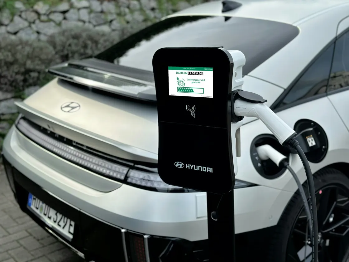 An electric vehicle connected to a charger, an illustrative photograph from AmpIQ's website